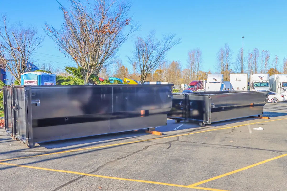 Professional dumpster rental service with roll-off container on residential driveway in Hayesville